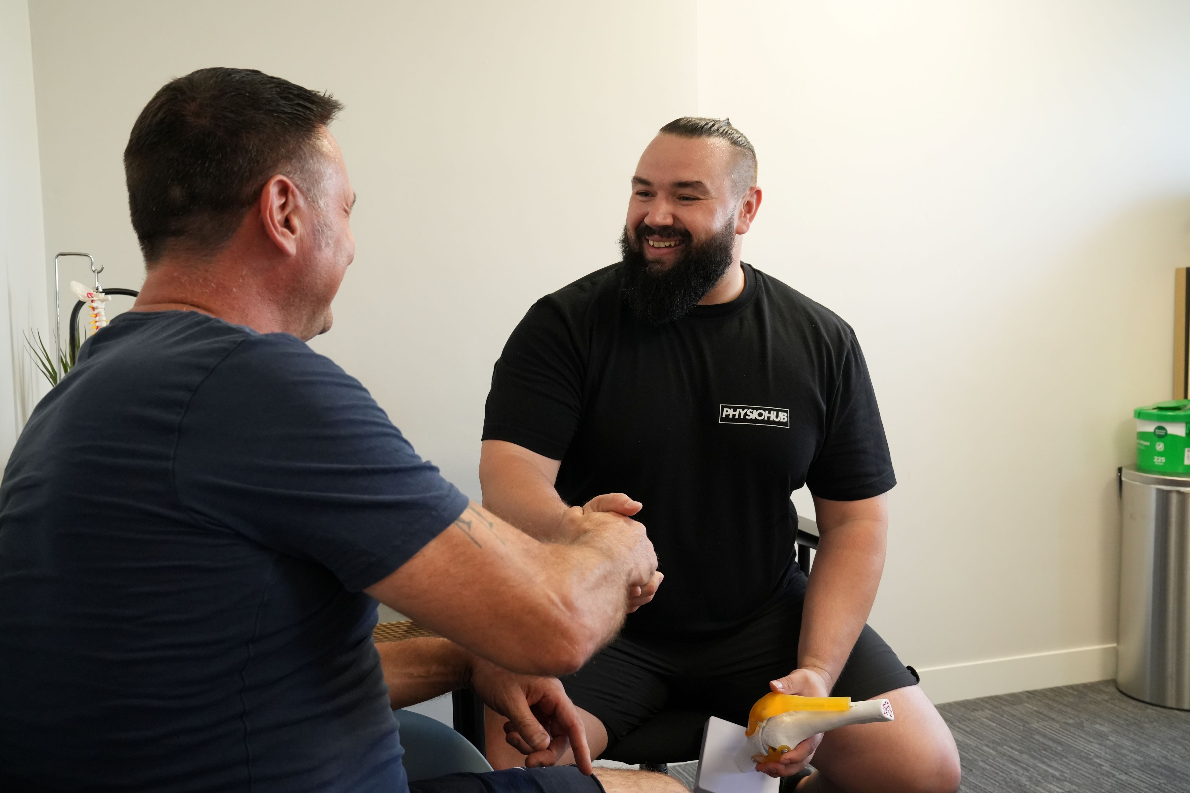 Physiotherapist carrying out a hands-on assessment of a patient's back