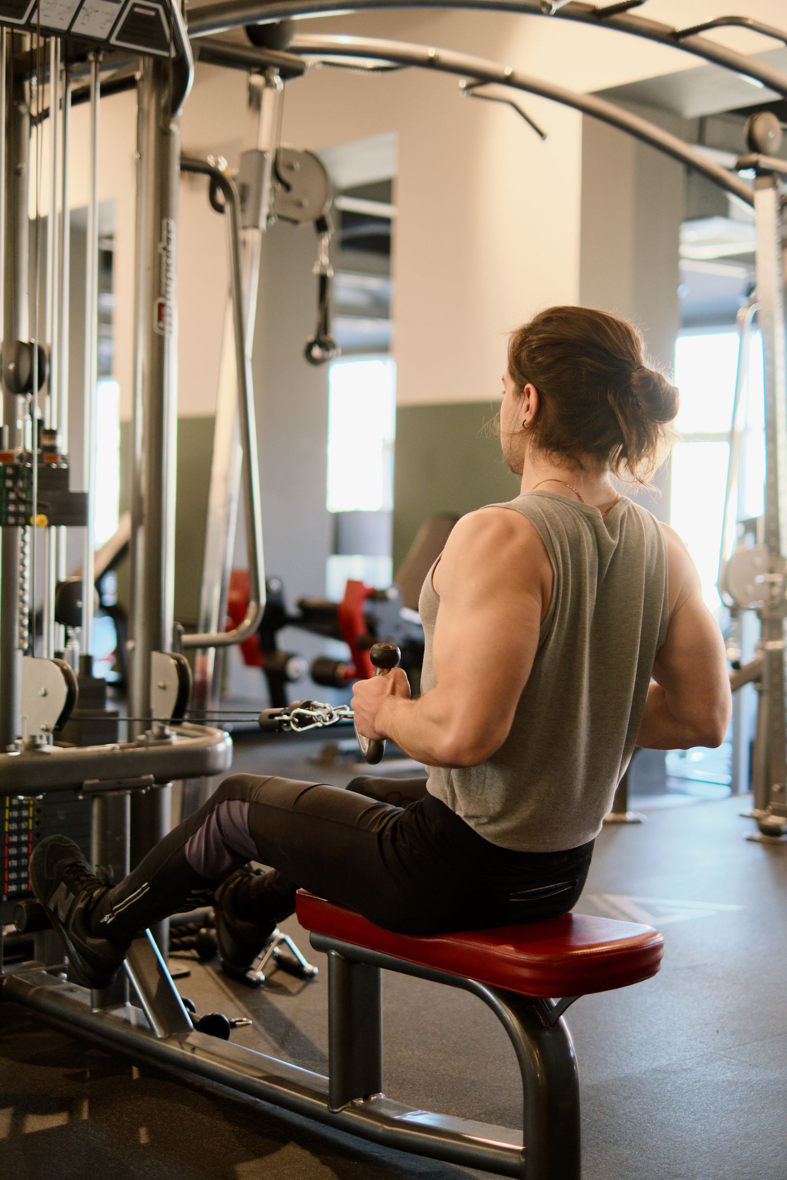 Person working through a strength test on a resistance machine in a gym