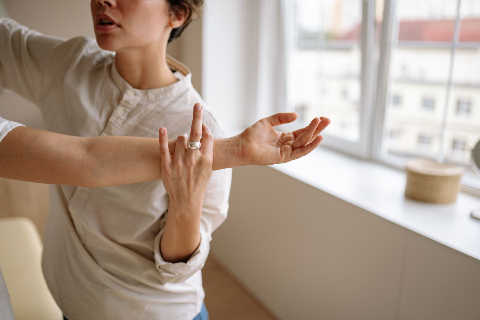 Person holding a painful forearm just below the elbow