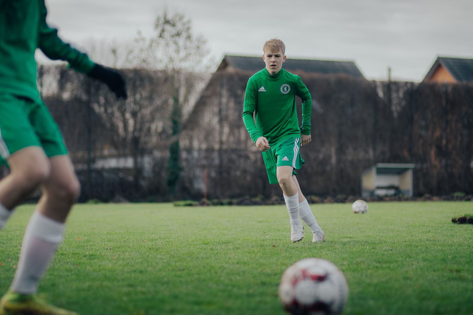 Amateur footballers training on a grass pitch