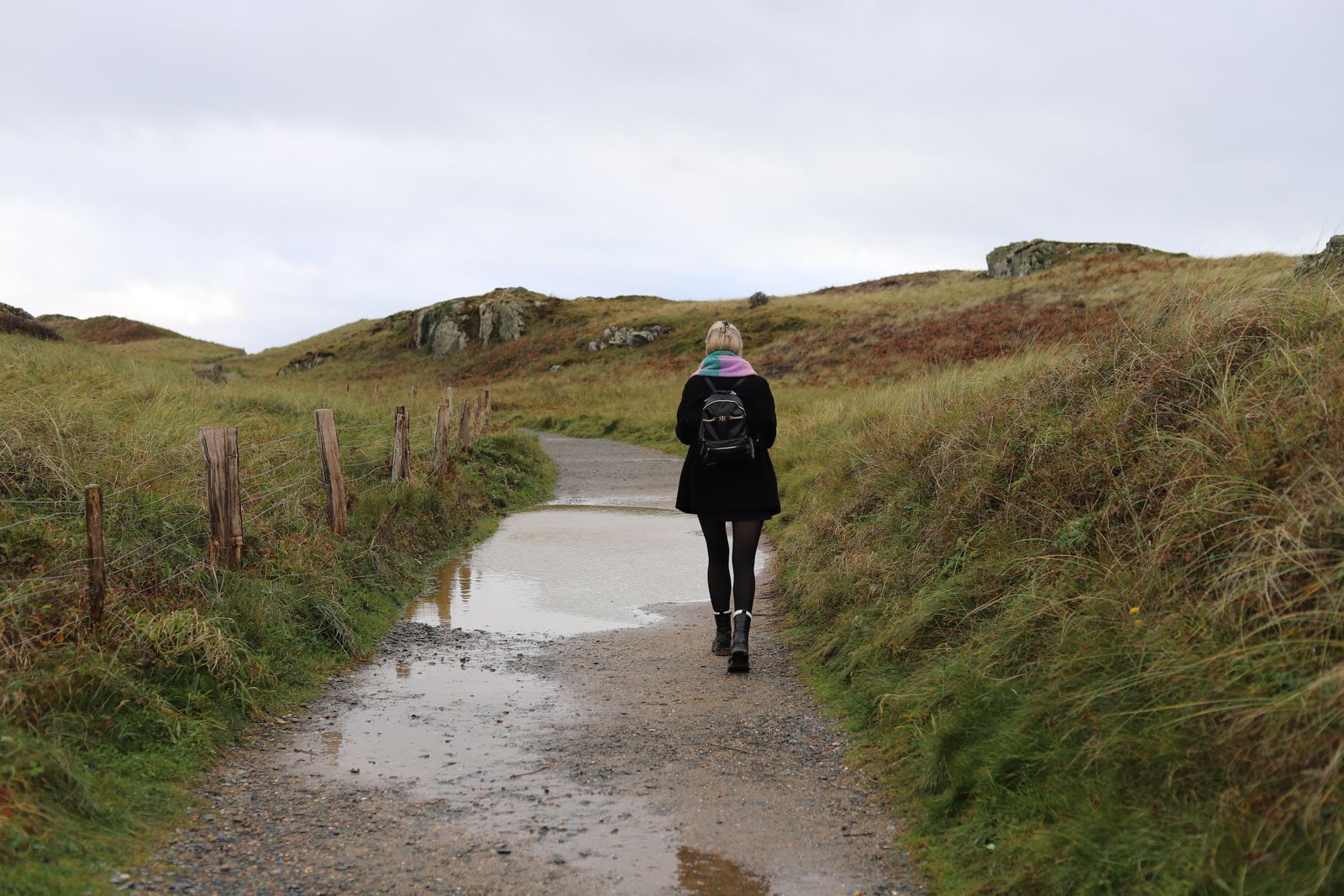 Person walking a countryside path on an overcast day