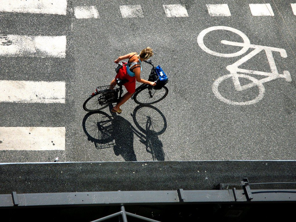A cyclist riding through a marked cycle lane, seen from above