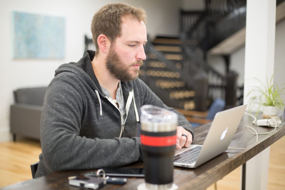 A man working at a laptop at a desk